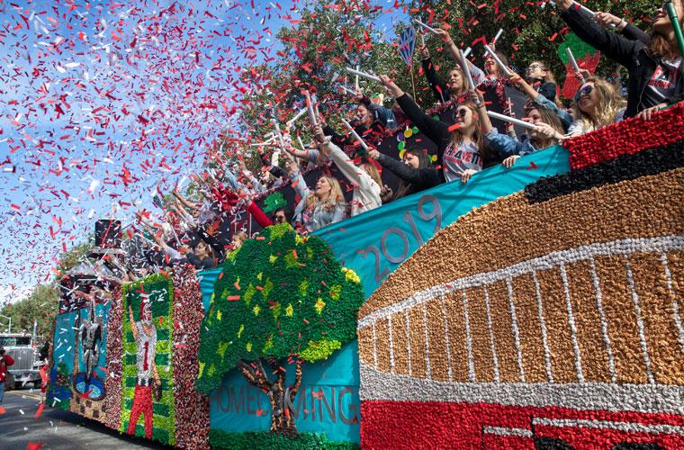 Red and white confetti around a float on St. Mary Boulevard for UL 69ý Homecoming