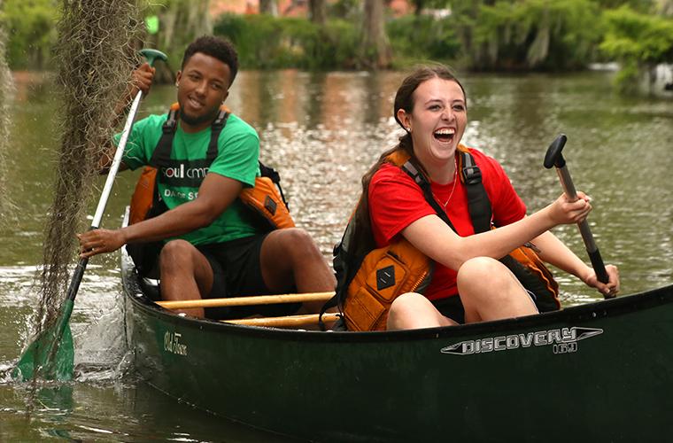 Students participate in canoe races in UL 69ý's Cypress Lake